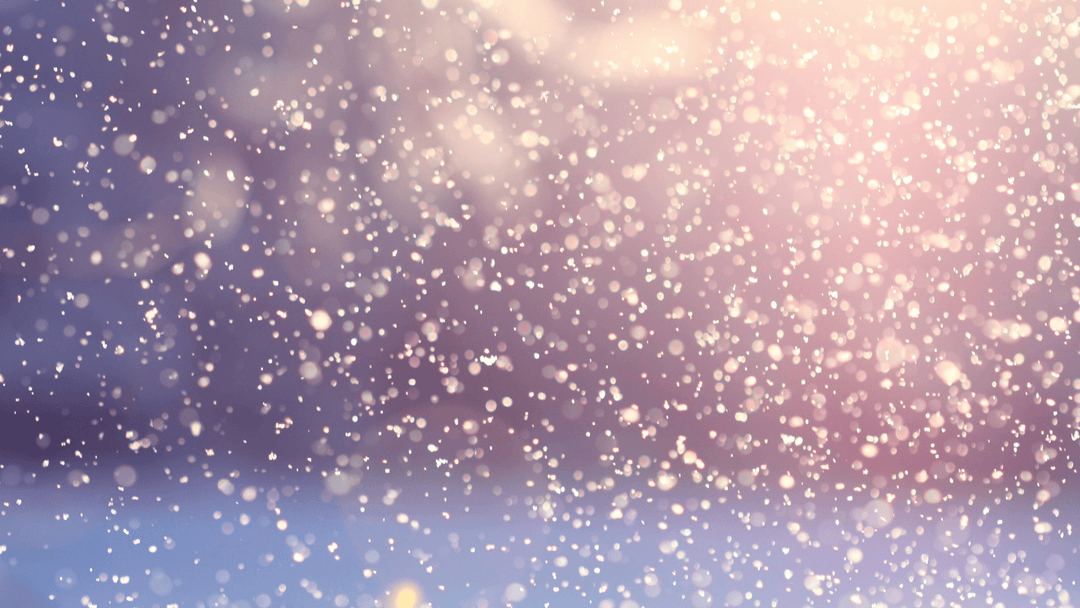 A blurry purple and pastel yellow image of sunlight shining through snowflakes