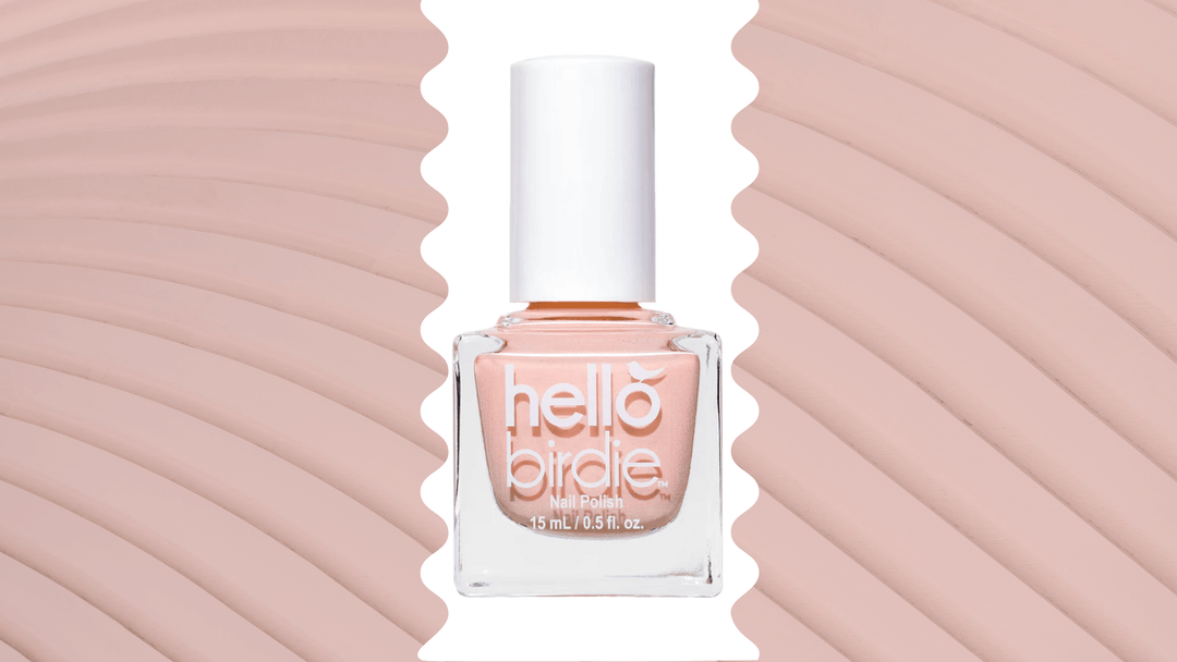 Hello Birdie classic pastel peach-pink polish Nest Friends Forever on top of a minimalist pink textured background