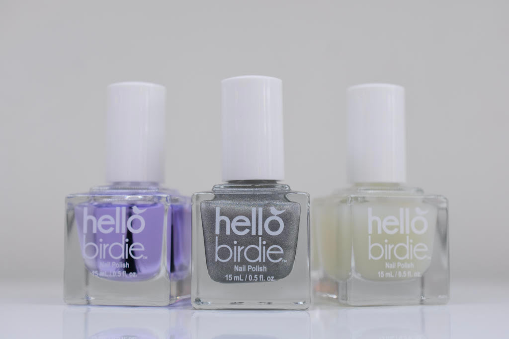 Row of three Hello Birdie classic polish top coats, from left to right is glossy, holographic, and matte.