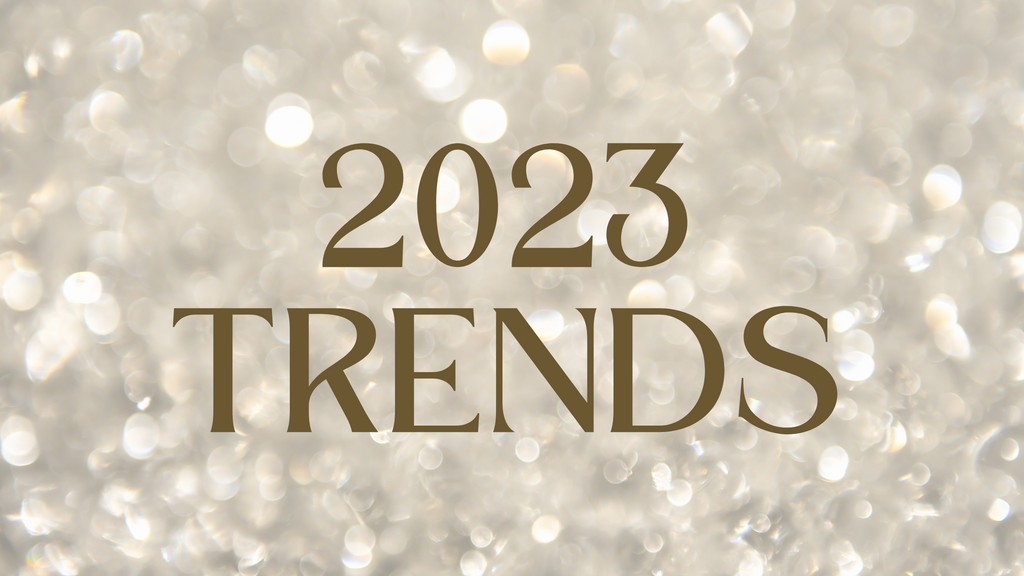 2023 Trends in a rich brown modern text over a gauzy champagne glitter background