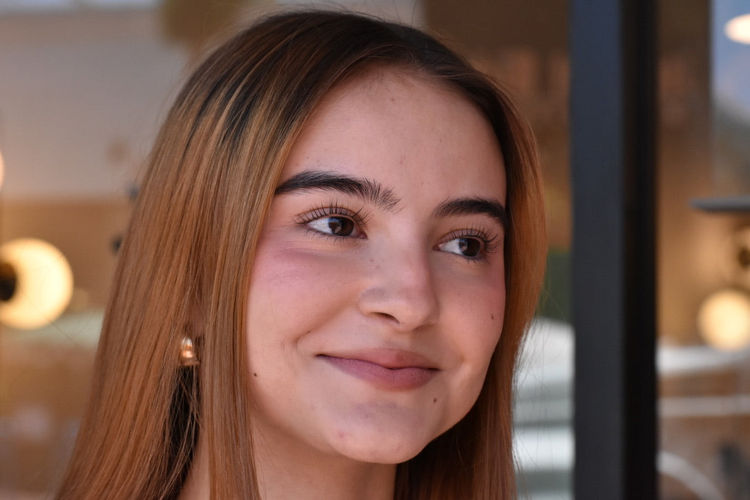 Close-up of a woman with a lash lift and a blurred background